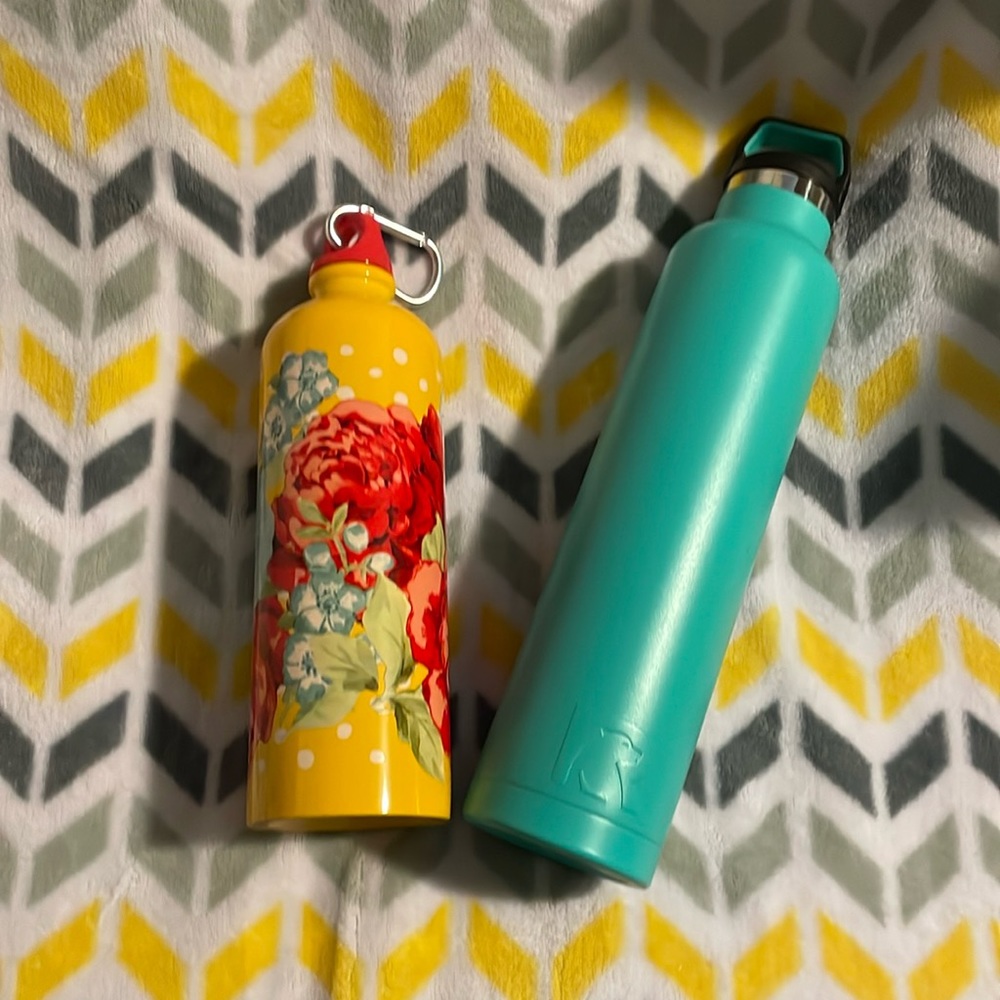 Two water bottles. Blue is RTIC. yellow is Pioneer Woman.